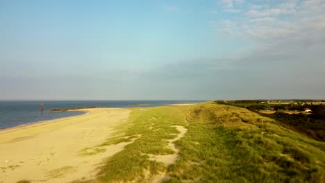 Eccles-sandy-sea-beach-with-scenic-grassland-at-Norfolk,-England---dolly-shot