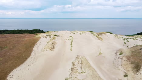 Flying-toward-end-of-sandy-dune-with-view-to-Curonian-lagoon