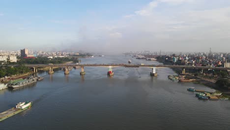 Aerial-flight-over-traffic-on-four-lane-Postogola-bridge-over-Buriganga-river