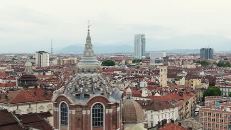 Aerial-View-Of-Turin-Cathedral-Tower,-Modern-Buildings-In-Background