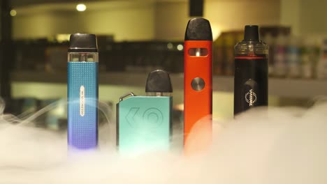 Vape-Devices-On-Counter-With-Smoke-Settling-Round-Them-Indoors-On-Counter