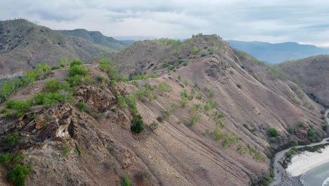 A-scattering-of-green-trees-on-the-hill-and-mountain-landscape-during-dry-season-in-Timor-Leste,-South-East-Asia