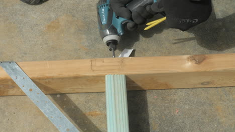 CLOSE-UP-Carpenter-Uses-Hand-Drill-To-Screw-Timber-Housing-Frame