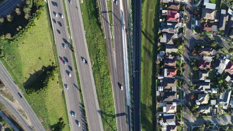 Smooth-tracking-perspective-from-drone-looking-top-down-at-busy-highway-interchange-below
