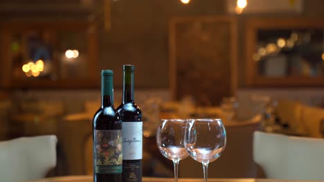 Glasses-of-wine-panning-slider-shot-at-night-restaurant