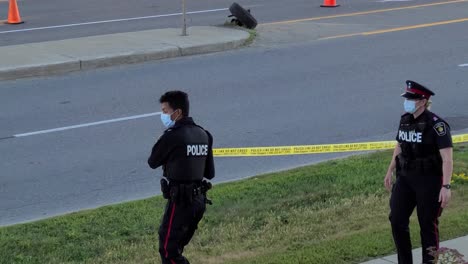 Police-Officers-In-Masks-Cordoning-Perimeter-Of-Fatal-Car-Crash-Accident-In-Vaughan,-Canada