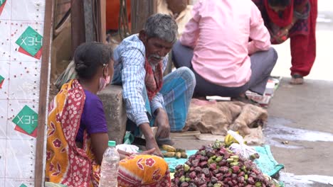 Poor-old-man-and-woman-hawker-selling-fruits-on-street,-slow-motion-shot