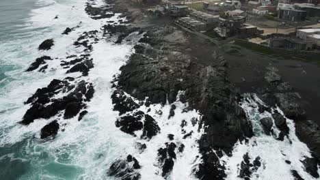 Aerial-orbit-of-the-rocks-off-the-coast-of-Pichilemu-with-a-strong-swell
