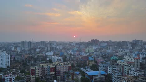 Red-an-orange-sunset-cityscape-of-Dhaka-city-urban-area-in-Bangladesh,-Asia