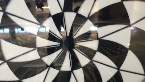 Black-And-White-Hypnosis-Spiral-Moving-Clockwise-On-The-Interior-Wall-With-Reflection-At-Terminal-3-Of-San-Francisco-International-Airport-In-California