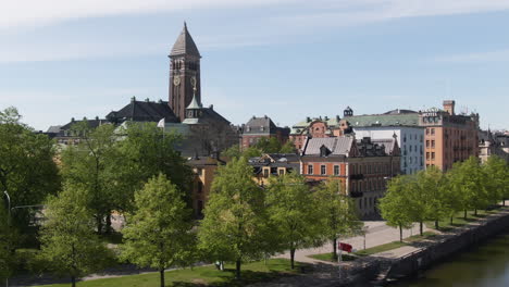 Norrkoping,-Sweden,-Aerial-Rise-Up-Motala-River-Fountain-And-City-Hall
