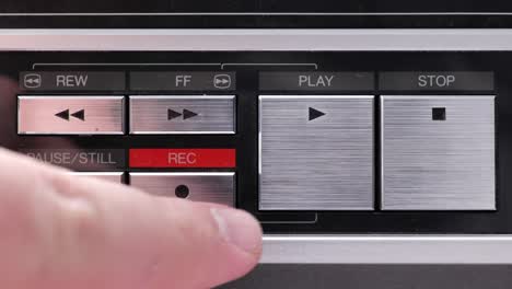Extreme-close-up-of-buttons-on-an-old-antique-or-vintage-VCR-pushing-Record