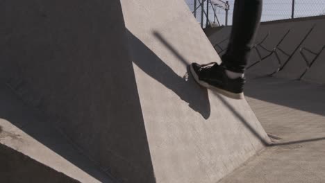 Close-up-on-the-foot-of-someone-testing-the-grip-of-a-wall-for-a-Parkour-jump-under-a-beautiful-sun-in-slow-motion