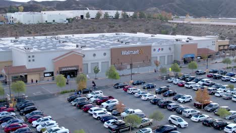 Aerial-establishing-shot-of-a-Walmart-Superstore-with-a-busy-car-park