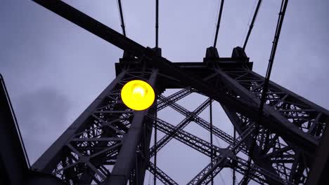 Metal-frame-of-suspension-bridge-in-New-York-with-hanging-glowing-light