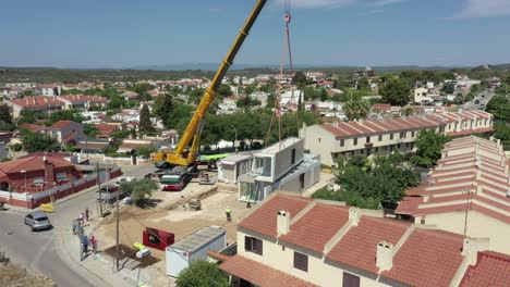 New-estate-being-built-and-a-large-crane-lifting-modular-homes-into-place