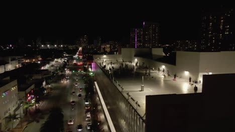 Night-aerial-on-Alton-Rd,-Miami-to-social-distance-Zumba-class-on-roof