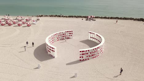 Miami-Beach-orbiting-aerial-of-art-installation,-Dreaming-with-Lions
