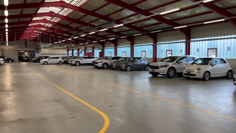 Slow-pan-of-new-cars-inside-Carvolution-HQ-in-Bannwil,-Switzerland