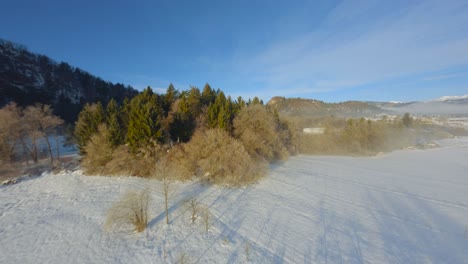 FPV-Drone-shot,-the-landscape-covered-under-the-fog-with-surrounding-mountains-in-the-morning-at-winter-time-in-Slovenia-captured-in-4k,-drone-flying-fast,-close-to-objects-with-lots-of-movement
