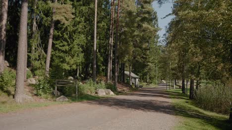 Entering-Kypegården-In-Late-Summer-With-people-Walking,-Borås-Sweden---Wide-Shot-Tracking-Forward