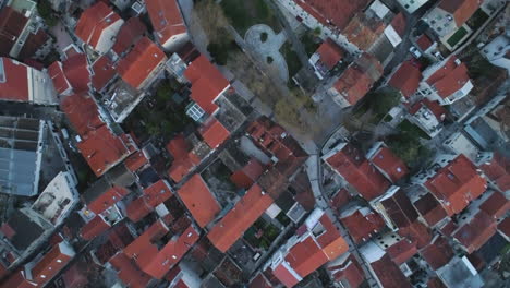 Many-red-rooftops-of-Split-city-in-Croatia-with-narrow-streets,-aerial-top-down-shot