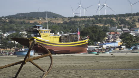 Urban-beach-in-Vietnam-with-wind-mill-turbines-on-hill-in-background