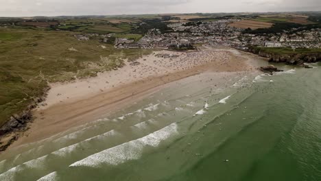 Perranporth-Beach-And-Sea-Full-Of-Summer-Surfers-and-Swimmers-Aerial-View