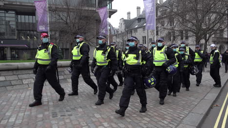 A-unit-of-Metropolitan-Territorial-Support-Group-riot-police-wearing-face-masks-march-while-policing-a-public-order-event