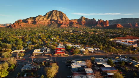 Cinematic-ascending-drone-shot-of-Sedona-Arizona-with-the-Airport-Mesa-mountain-in-the-distance