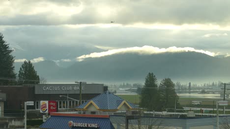 An-overview-of-a-helicopter-flies-over-flooded-farmland-in-Abbotsford-and-businesses-at-the-front