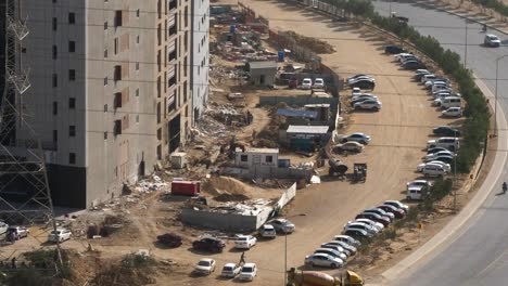 Row-Of-Cars-Parked-Beside-Construction-Site-In-Bahria-Town-Karachi