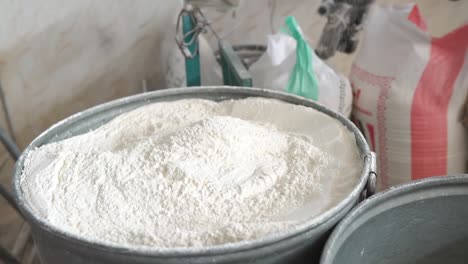 Worker-Scooping-Fresh-White-Flour-From-Sack-At-Factory-In-Pakistan
