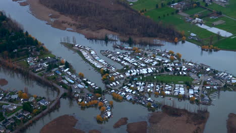 High-Aerial-Shot-of-Flooded-Trailer-Park-next-to-River,-Vancouver-Area
