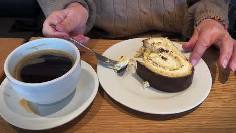 Elderly-hands-eating-cake-with-coffee