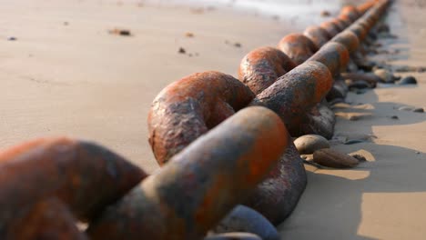 Rusty-Anchor-Chain-Laid-Out-On-Beach