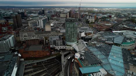 Cinematic-aerial-view-over-Birmingham-City-in-the-UK-showing-the-landmark-Bullring,-Grand-Central-Mall-and-New-Street-Rail-Station