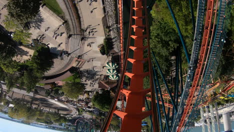 Front-seat-view-of-exhilarating-rollercoaster-going-down-steep-drop-at-amusement-park
