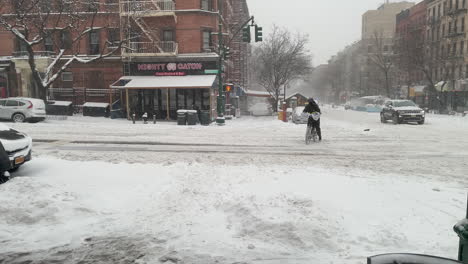 Delivery-Driver-Rides-Bike-Onto-Sidewalk-Through-Deep-Snow-In-New-York-City