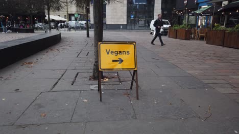 A-Vegan-sign-outside-a-line-of-restaurants