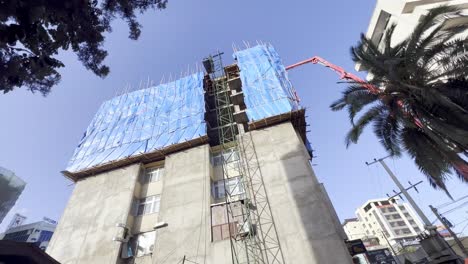 high-rise-concrete-pump-in-usage-in-addis-ababa-ethiopia-with-stick-scaffolding-in-use
