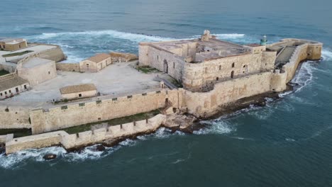 Low-Aerial-of-the-Castle-and-Lighthouse-of-Syracuse-in-the-Mediterranean-Sea