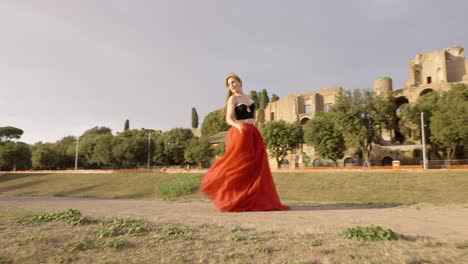 Beautiful-woman-dancing-in-a-red-dress,-rotating-pull-away-shot