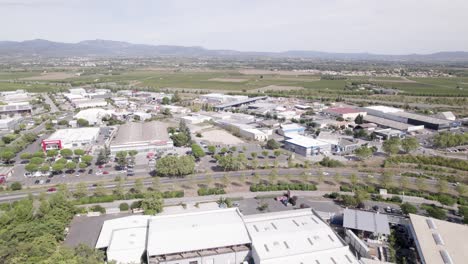 Commercial-shopping-center,-stores-and-roads-on-the-outskirts-of-town,-Aerial-pan-right-shot
