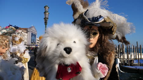 Absurd-periodic-volto-masked-performer-with-pet-dog-at-Venice-carnival