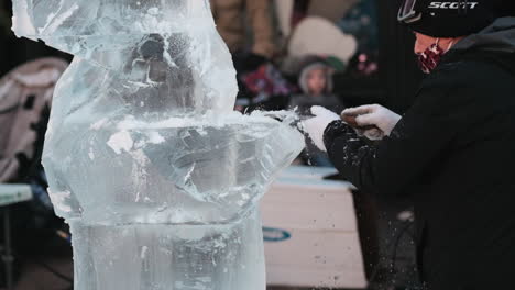Static-shot-of-ice-sculptor-shaping-large-ice-block