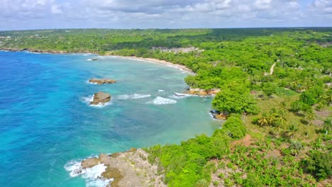 Idyllic-Aerial-View-above-Picturesque-Caribbean-Coastline,-Lush-Tropical-Vegetation-and-Turquoise-Blue-Ocean---gentle-zoom-out-shot