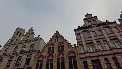 Looking-up-at-medieval-buildings,-facades-in-Bruges,-the-capital-of-West-Flanders-in-the-northwest-of-Belgium