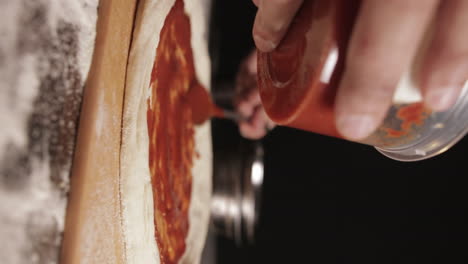Slow-Motion-Of-Ready-made-Pizza-Sauce-Being-Spread-On-Pizza-Dough-Before-Baking