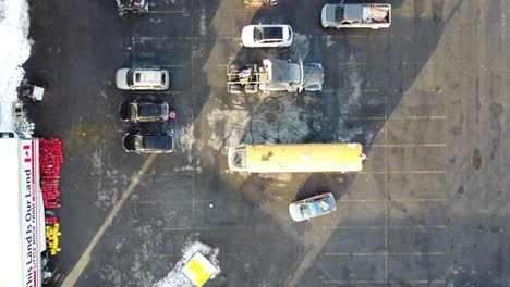 Drone-birds-eye-view-of-trucks-and-tents-in-the-parking-lot-on-a-winter-day
